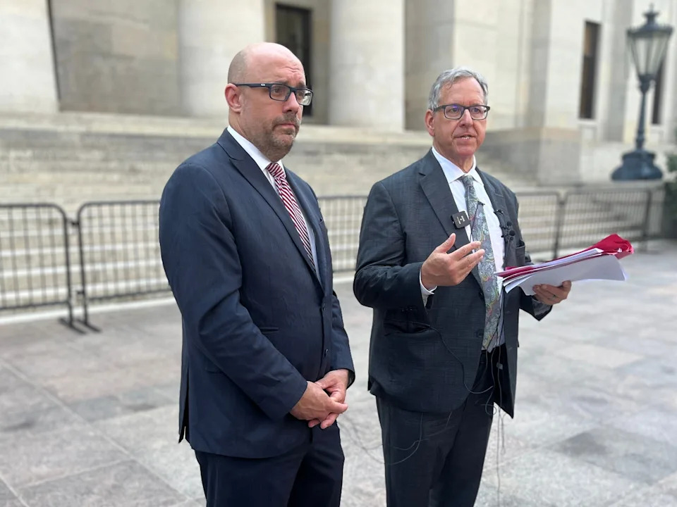 Former state Representative Jeff Crossman and former Ohio Attorney General Marc Dann speak to the media outside the Ohio Statehouse on June 25, 2025 about their plan to sue over the state's use of unclaimed funds for the new Browns stadium.
