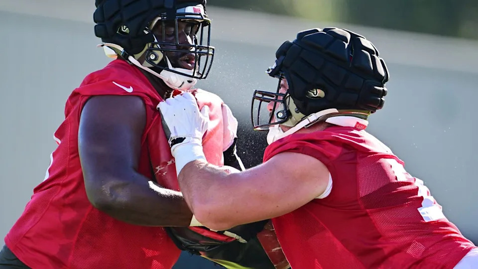 <div>TAMPA, FLORIDA - JULY 24: Charlie Heck #77 works out with Ben Chukwuma #70 of the Tampa Bay Buccaneers during the 2025 Tampa Bay Buccaneers Training Camp at AdventHealth Training Center on July 24, 2025 in Tampa, Florida. (Photo by Julio Aguilar/Getty Images)</div>