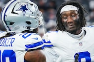 Dallas Cowboys linebacker Demarvion Overshown (0) shakes hands with free safety Malik Hooker...