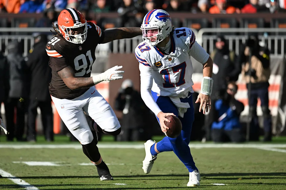 Dec 21, 2025; Cleveland, Ohio, USA; Buffalo Bills quarterback Josh Allen (17) is pressured by Cleveland Browns defensive end Alex Wright (91) during the first half at Huntington Bank Field. Mandatory Credit: Ken Blaze-Imagn Images
