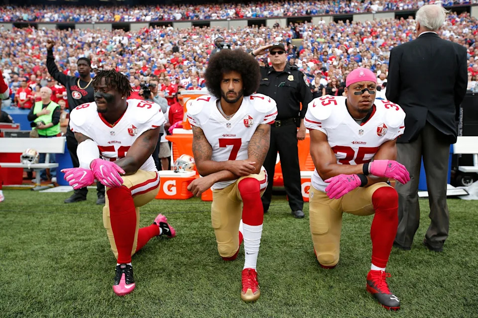 Michael Zagaris/San Francisco 49ers/Getty Images - PHOTO:Eli Harold #58, Colin Kaepernick #7 and Eric Reid #35 of the San Francisco 49ers kneel in protest on the sideline, during the anthem, prior to the game against the Buffalo Bills at New Era Field, Oct. 16, 2016, in Orchard Park, N.Y.