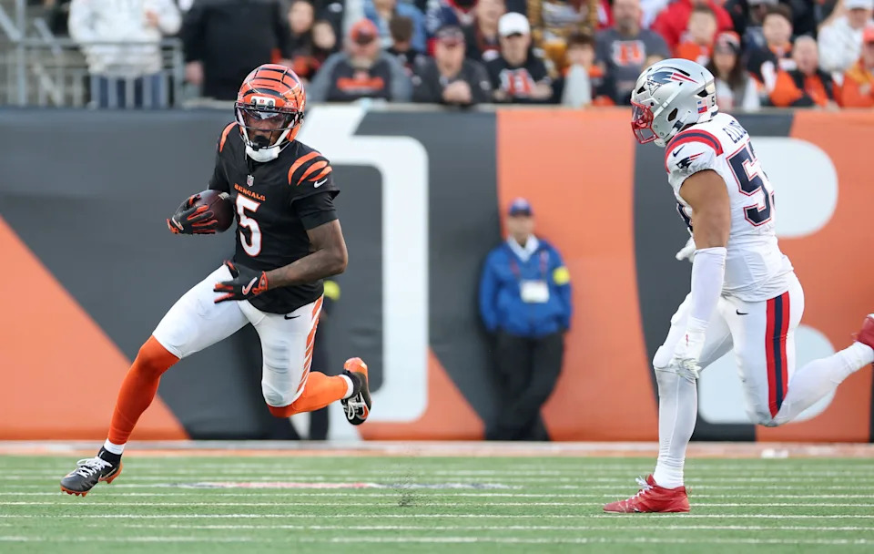Nov 23, 2025; Cincinnati, Ohio, USA; Cincinnati Bengals wide receiver Tee Higgins (5) runs against New England Patriots linebacker Christian Elliss (53) during the second half at Paycor Stadium. Mandatory Credit: Joseph Maiorana-Imagn Images