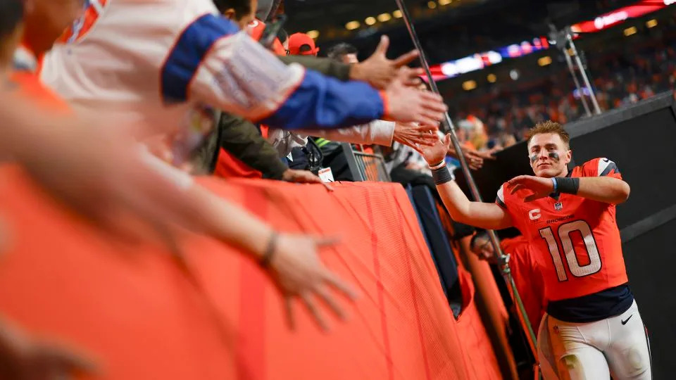 Denver Broncos QB Bo Nix celebrates with fans after defeating the Green Bay Packers on December 14. - Justin Edmonds/Getty Images