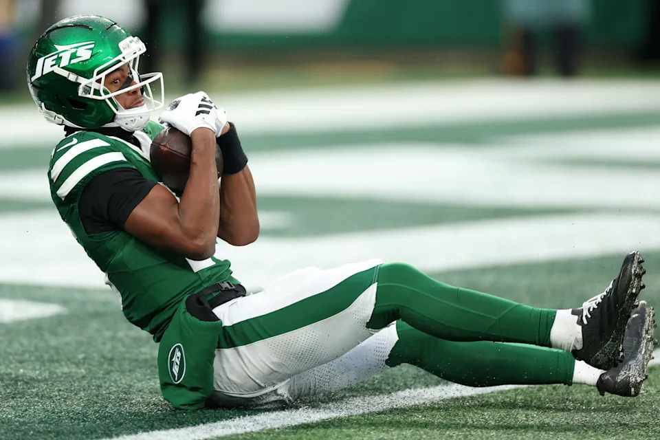 Nov 30, 2025; East Rutherford, New Jersey, USA;New York Jets wide receiver Adonai Mitchell (15) makes a touchdown catch against the Atlanta Falcons during the second half at MetLife Stadium. Mandatory Credit: Vincent Carchietta-Imagn Images