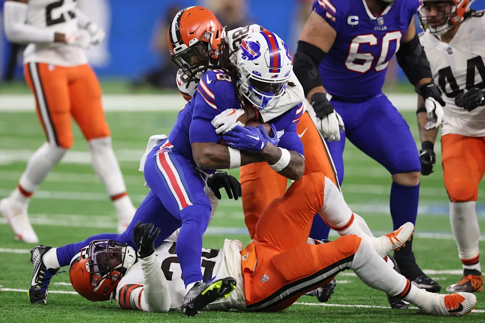 DETROIT, MICHIGAN - NOVEMBER 20: Jeremiah Owusu-Koramoah #28 of the Cleveland Browns and A.J. Green #38 of the Cleveland Browns tackle James Cook #28 of the Buffalo Bills during the third quarter at Ford Field on November 20, 2022 in Detroit, Michigan. (Photo by Gregory Shamus/Getty Images)