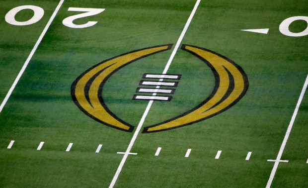 The College Football Playoff logo is shown on the field at AT&T Stadium before the Rose Bowl NCAA college football game between Notre Dame and Alabama in Arlington, Texas, Jan. 1, 2021. The field for the 12-team College Football Playoff will comprise five conference champions and seven at-large selections after the university presidents who oversee the CFP voted unanimously Tuesday, Feb. 20, 2024, to tweak the format. (AP Photo/Roger Steinman, File)