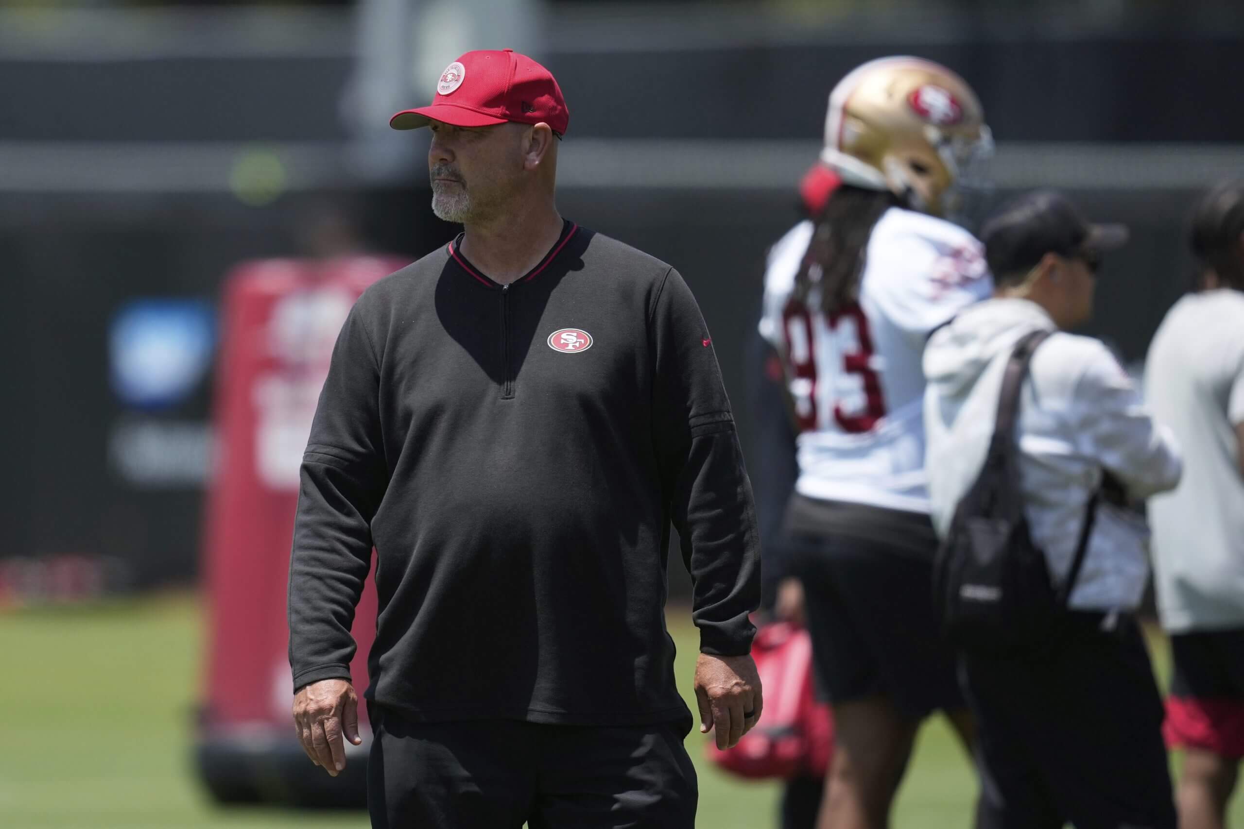 San Francisco 49ers defensive assistant coach Gus Bradley watches players run drills during practice.