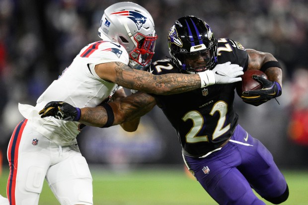 Baltimore Ravens running back Derrick Henry (22) runs against New England Patriots cornerback Christian Gonzalez during the second half of an NFL game Sunday night. (AP Photo/Nick Wass)