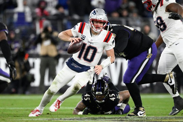 New England Patriots quarterback Drake Maye (10) runs against the Baltimore Ravens during the second half of an NFL game in Baltimore on Sunday. (AP Photo/Nick Wass)