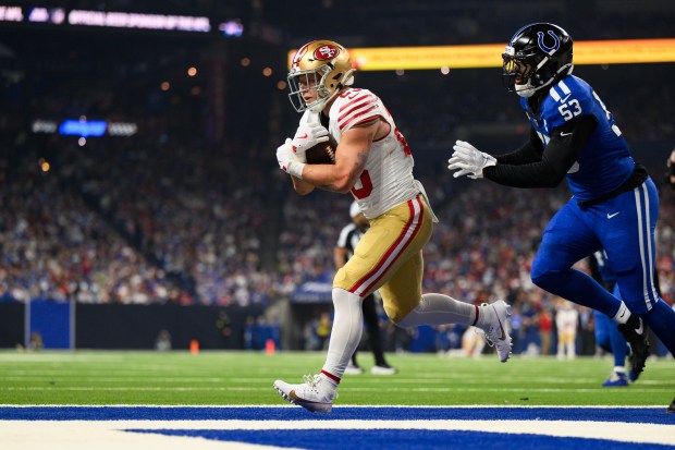 San Francisco 49ers running back Christian McCaffrey (23) runs in for a touchdown during an NFL football game against the Indianapolis Colts, Monday, Dec. 22, 2025, in Indianapolis. (AP Photo/Zach Bolinger)