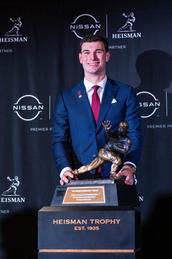 Heisman Trophy finalist Indiana quarterback Fernando Mendoza poses with the trophy after an NCAA college football news conference before the award ceremony, Saturday, Dec. 13, 2025, in New York.