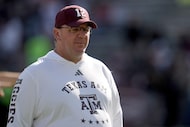 Texas A&M head coach Mike Elko watches his team warmup before the start of an NCAA college...