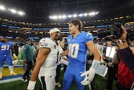 Los Angeles Chargers quarterback Justin Herbert (10) hugs Philadelphia Eagles quarterback...