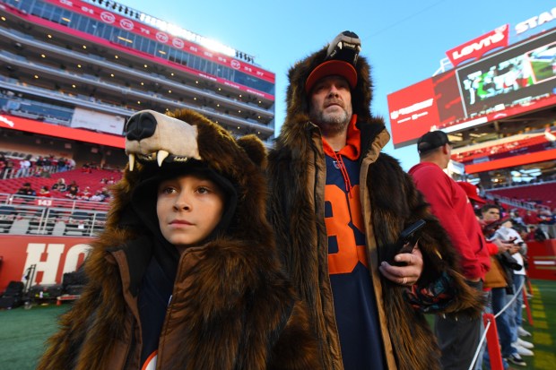 Roger Warren, 7, of Newark, stands with his father Matt Warren as they watch the Chicago Bears warm up before their NFL game at Levi's Stadium in Santa Clara, Calif., on Sunday, Dec. 28, 2025. (Jose Carlos Fajardo/Bay Area News Group)