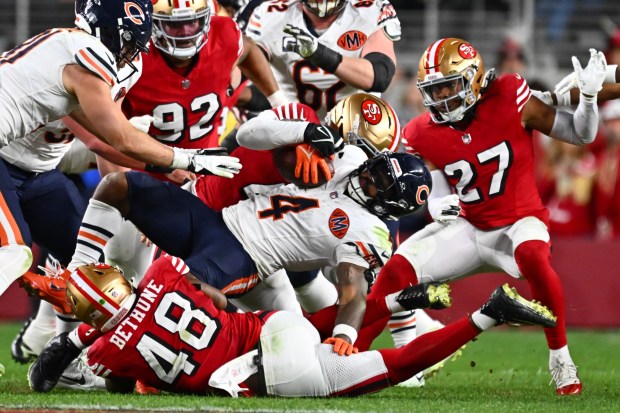 Chicago Bears' D'Andre Swift (4) is stopped by the San Francisco 49ers defense in the fourth quarter of their NFL game at Levi's Stadium in Santa Clara, Calif., on Sunday, Dec. 28, 2025. The San Francisco 49ers defeated the Chicago Bears 42-38. (Jose Carlos Fajardo/Bay Area News Group)
