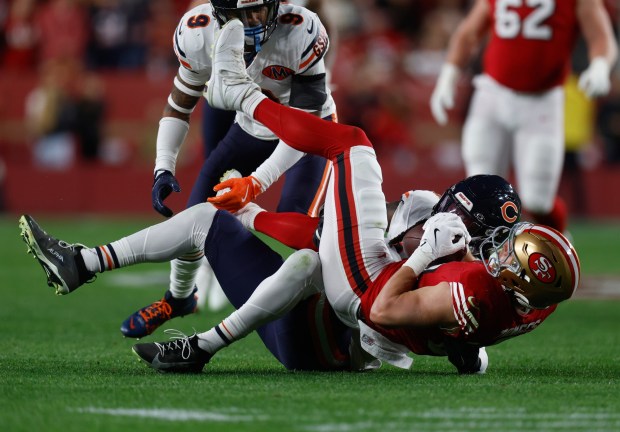 San Francisco 49ers' Jake Tonges (88) comes down with a pass against Chicago Bears' Tremaine Edmunds (49) in the first quarter at Levi's Stadium in Santa Clara, Calif., on Sunday, Dec. 28, 2025. (Nhat V. Meyer/Bay Area News Group)