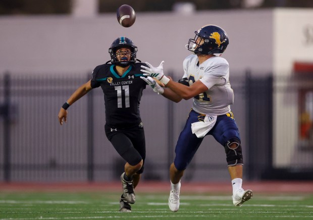 Lincoln's Kyan Phillips (21) catches the ball against Valley Center's Brandon Revelas (11) in the second quarter during Division 6-AA state football championship game at Fullerton Union High School District Stadium in Fullerton, Calif., on Friday, Dec. 12, 2025. (Shae Hammond/Bay Area News Group)