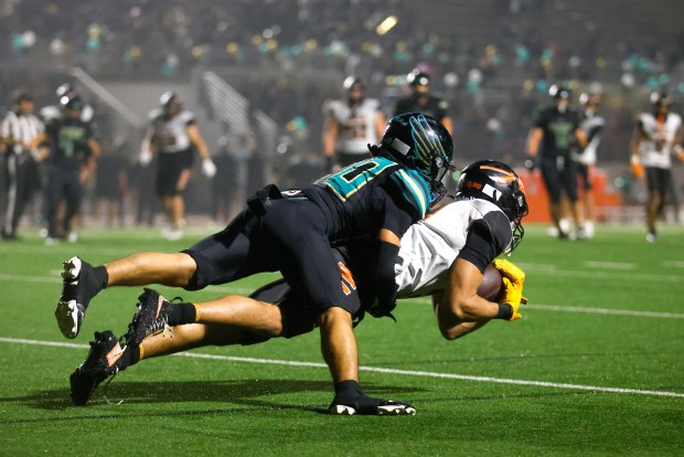 McClymonds' Prince Staten (3) catches the ball for a touchdown against Kennedy-Delano's Julian Contreras (20) in the fourth quarter during the Division 3-A state championship football game at Fullerton Union High School District Stadium in Fullerton, Calif., on Saturday, Dec. 13, 2025. (Shae Hammond/Bay Area News Group)