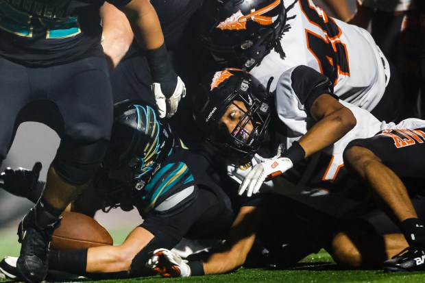 Kennedy-Delano's Jace Demacabalin (10) scores a touchdown against McClymonds' Jessie King Jr (5) and McClymonds' Robert Hunter (40) in the third quarter during the Division 3-A state championship football game at Fullerton Union High School District Stadium in Fullerton, Calif., on Saturday, Dec. 13, 2025. (Shae Hammond/Bay Area News Group)