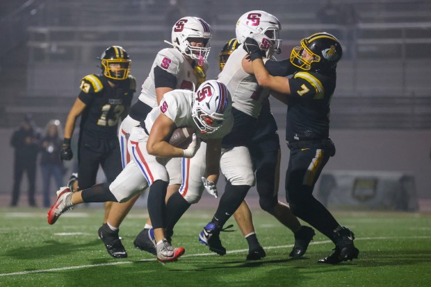 St. Ignatius' Elijah Farrah (18) scores a touchdown while St. Ignatius' Jonah Chavez (77) blocks Ventura's Dylan Klinzing (7) and St. Ignatius' Zachary Elias (54) blocks Ventura's Landen Alexander (32) in the third quarter during the Division 3-AA state championship football game at Fullerton Union High School District Stadium in Fullerton, Calif., on Friday, Dec. 12, 2025. (Shae Hammond/Bay Area News Group)