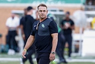 North Texas head coach Eric Morris walks the field before an NCAA football game against...