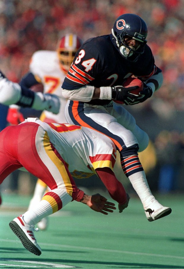 Bears running back Walter Payton eludes a Washington defender during a playoff game on Jan. 10, 1988 (John Swart/AP)