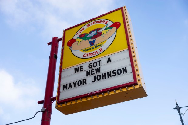 The marquee promoted Bears coach Ben Johnson as fans line up for free hot dogs, Dec. 2, 2025, at The Wieners Circle in Chicago's Lincoln Park neighborhood after Johnson took his shirt off in a postgame celebration for a win over the Eagles. (Brian Cassella/Chicago Tribune)