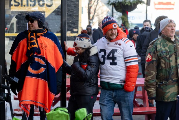 Bears fans line up for free hot dogs, Dec. 2, 2025, at The Wieners Circle in Chicago's Lincoln Park neighborhood after coach Ben Johnson took his shirt off in a postgame celebration for a win over the Eagles. (Brian Cassella/Chicago Tribune)