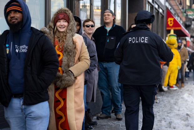 Shannon Lahey-Petzold dresses for the occassion as Bears fans line up for free hot dogs, Dec. 2, 2025, at The Wieners Circle in Chicago's Lincoln Park neighborhood after coach Ben Johnson took his shirt off in a postgame celebration for a win over the Eagles. (Brian Cassella/Chicago Tribune)