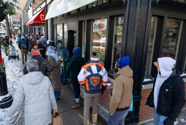 Bears fans line up around the block for free hot dogs, Dec. 2, 2025, at The Wieners Circle in Chicago's Lincoln Park neighborhood after coach Ben Johnson took his shirt off in a postgame celebration for a win over the Eagles. (Brian Cassella/Chicago Tribune)