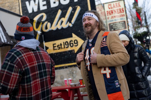 Bob Keen lines up with Bears fans for free hot dogs, Dec. 2, 2025, at The Wieners Circle in Chicago's Lincoln Park neighborhood after coach Ben Johnson took his shirt off in a postgame celebration for a win over the Eagles. (Brian Cassella/Chicago Tribune)