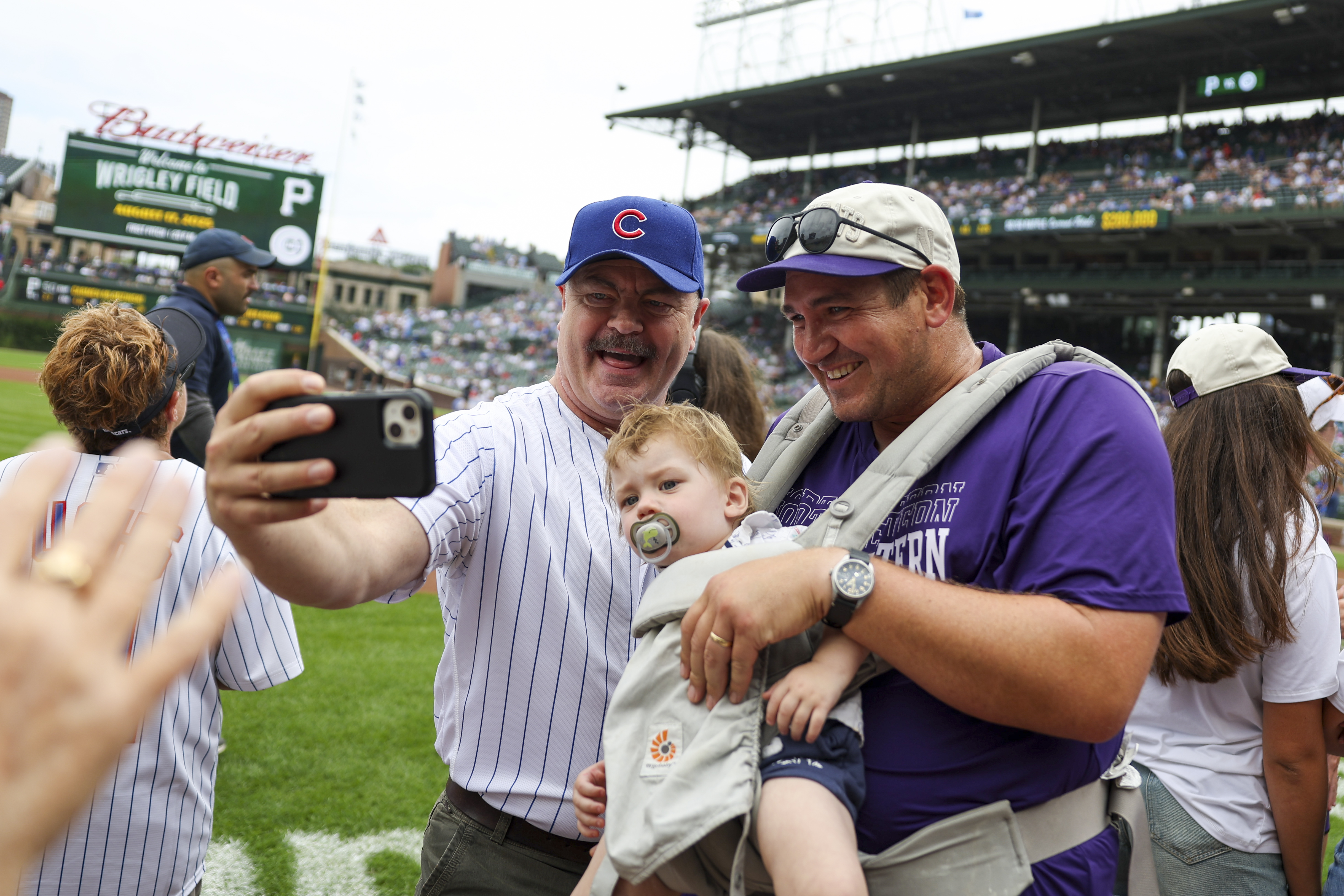 Actor Nick Offerman, left, poses for a selfie with Northwestern...