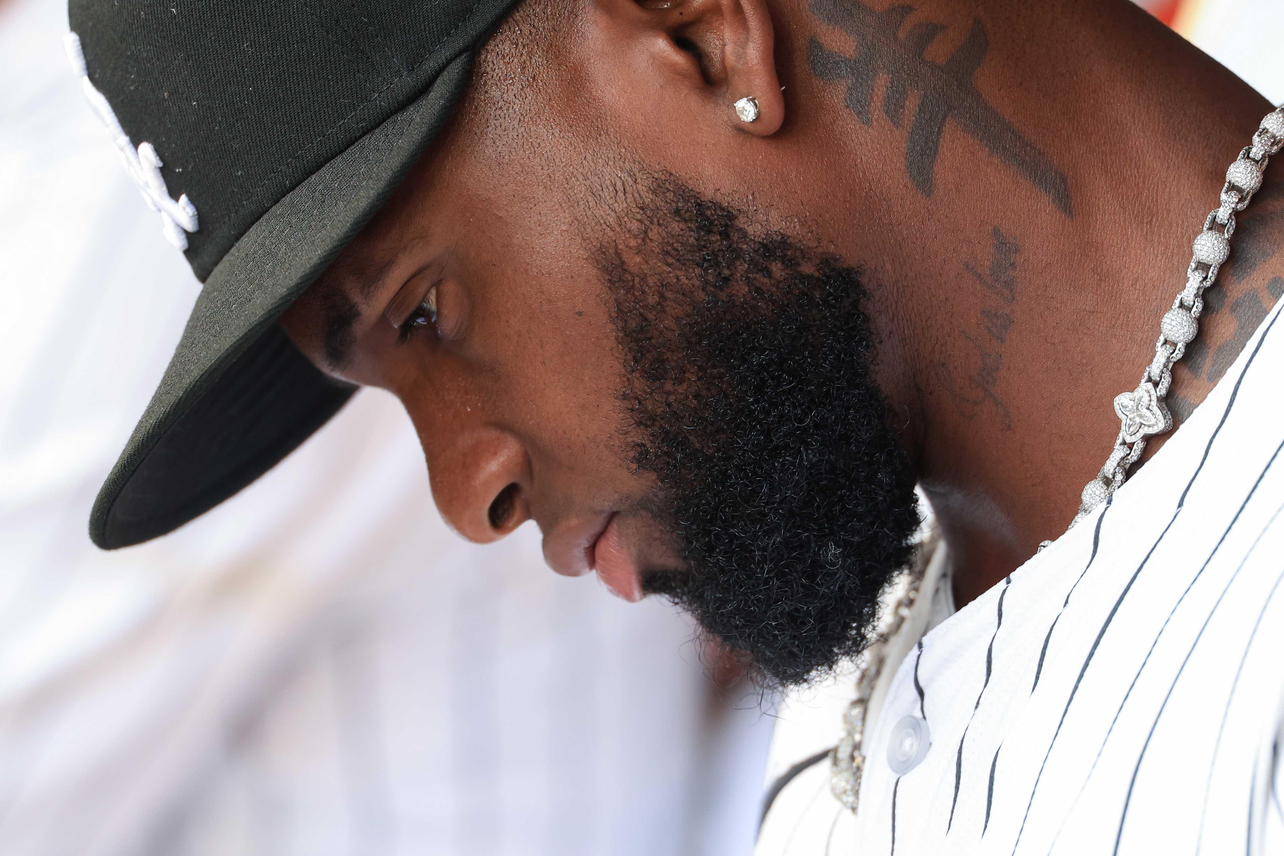 White Sox center fielder Luis Robert Jr. sits in the...