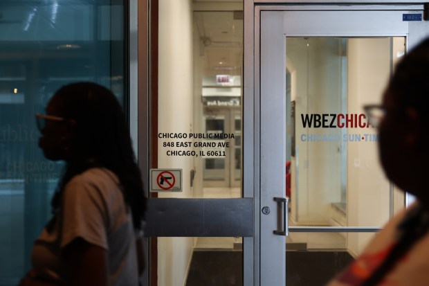 People walk past the entrance to the Chicago Public Media and WBEZ newsroom at Navy Pier on July 15, 2025. (John J. Kim/Chicago Tribune)