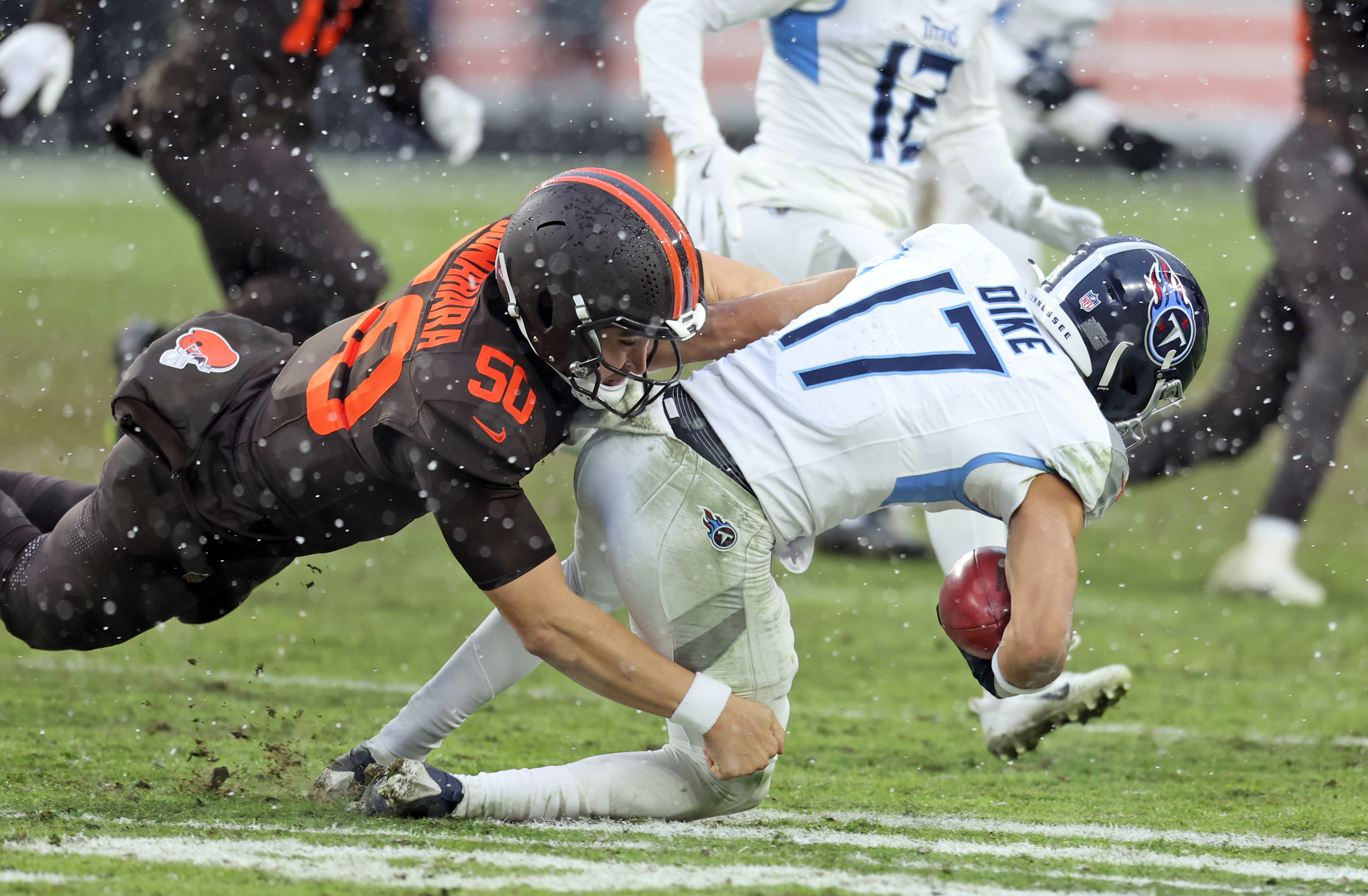 Cleveland Browns long snapper Rex Sunahara tackles Tennessee Titans wide receiver Chimere Dike on a punt return in the second half of play. 