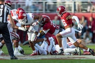 Oklahoma running back Xavier Robinson (24) runs the ball against Alabama linebacker Deontae...