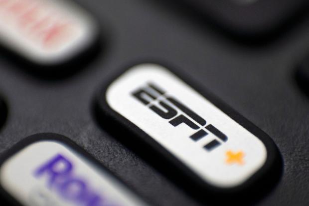 FILE This Aug. 13, 2020 file photo shows a logo for ESPN on a remote control, in Portland, Ore. (AP Photo/Jenny Kane, FIle)