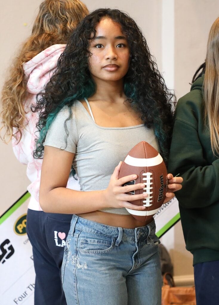 player on the Franklin girls flag football team holding a football