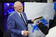 Dallas Cowboys owner Jerry Jones signs autographs prior to an NFL football game against the...