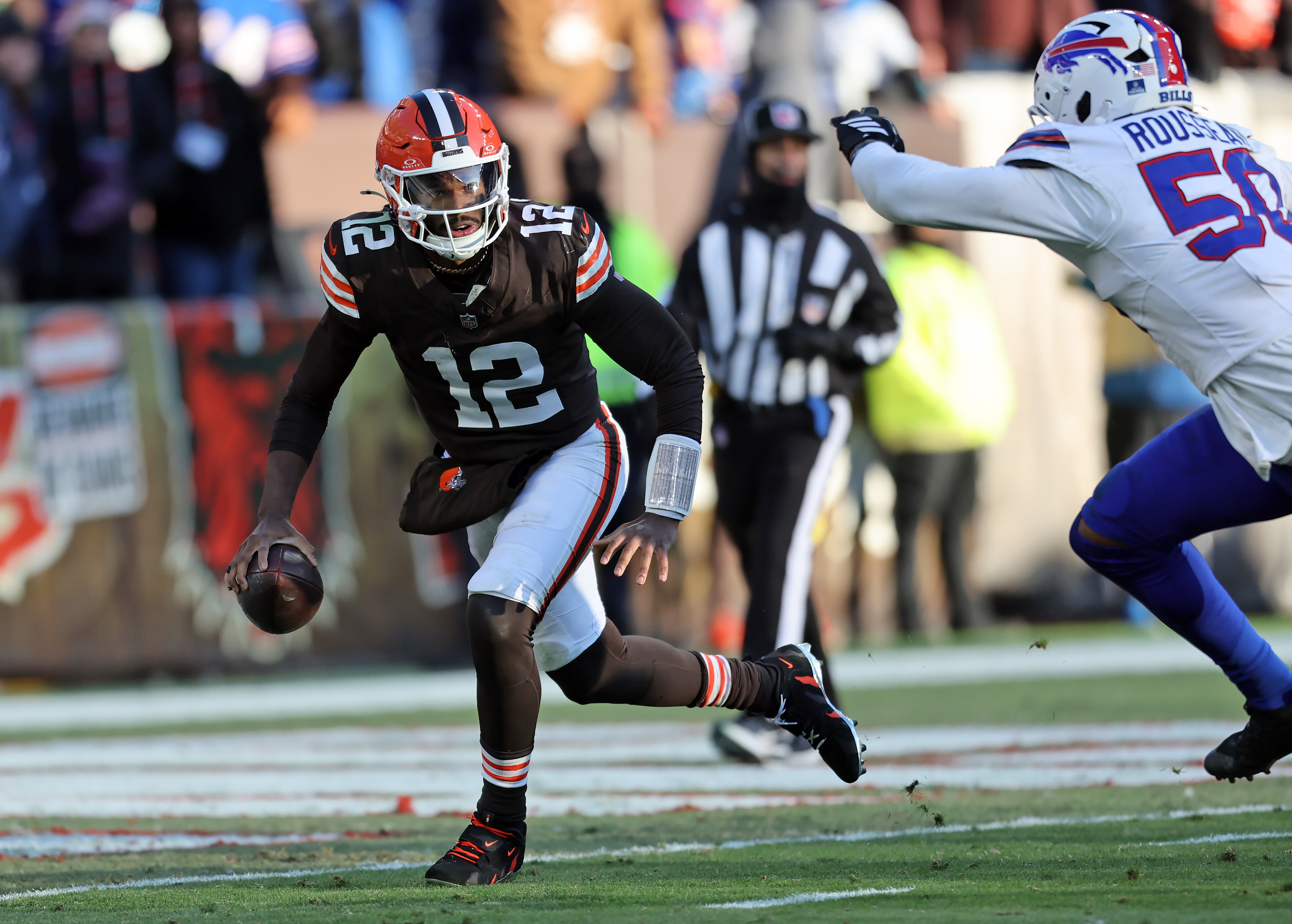 Cleveland Browns quarterback Shedeur Sanders scrambles under pressure from Buffalo Bills defensive end Greg Rousseau in the second half. 