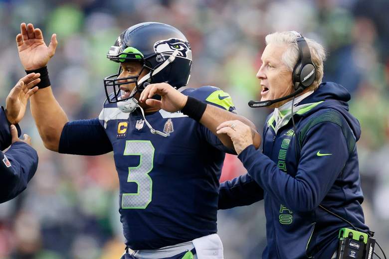 Seattle Seahawks former player and coach, Russell Wilson and Pete Carroll, share the field.