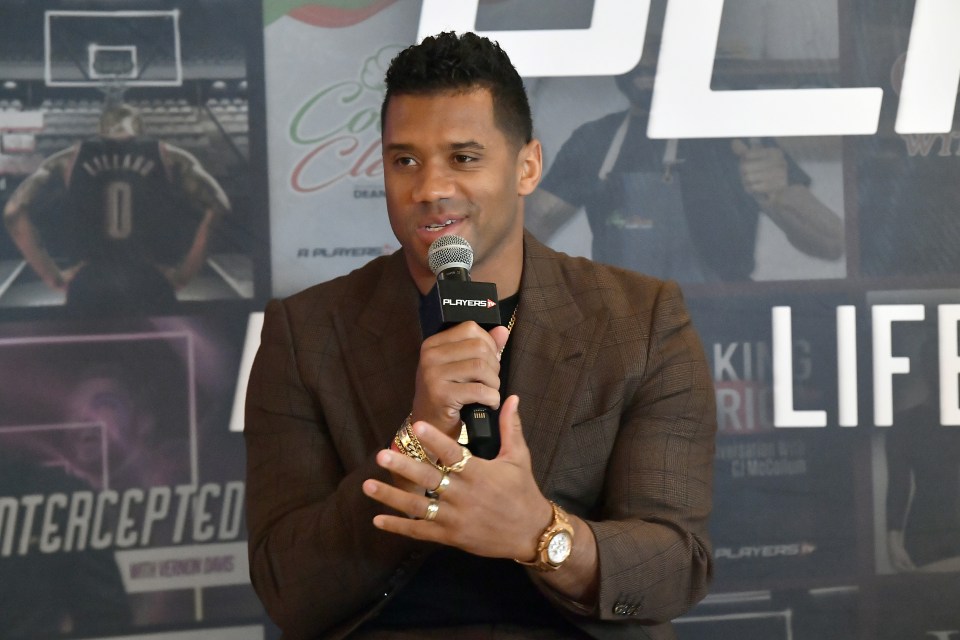 Professional football player and Why Not You Productions founder Russell Wilson speaks during the PlayersTV press conference