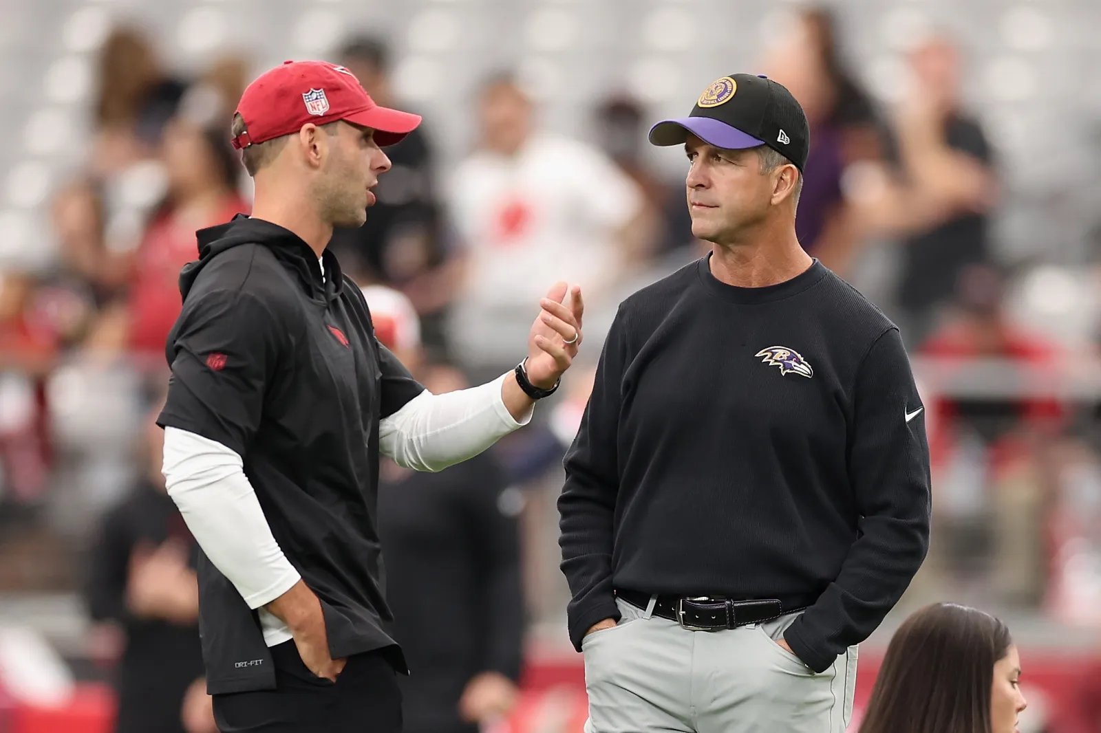 Arizona Cardinals head coach Jonathan Gannon speaks with Baltimore Ravens head coach John Harbaugh