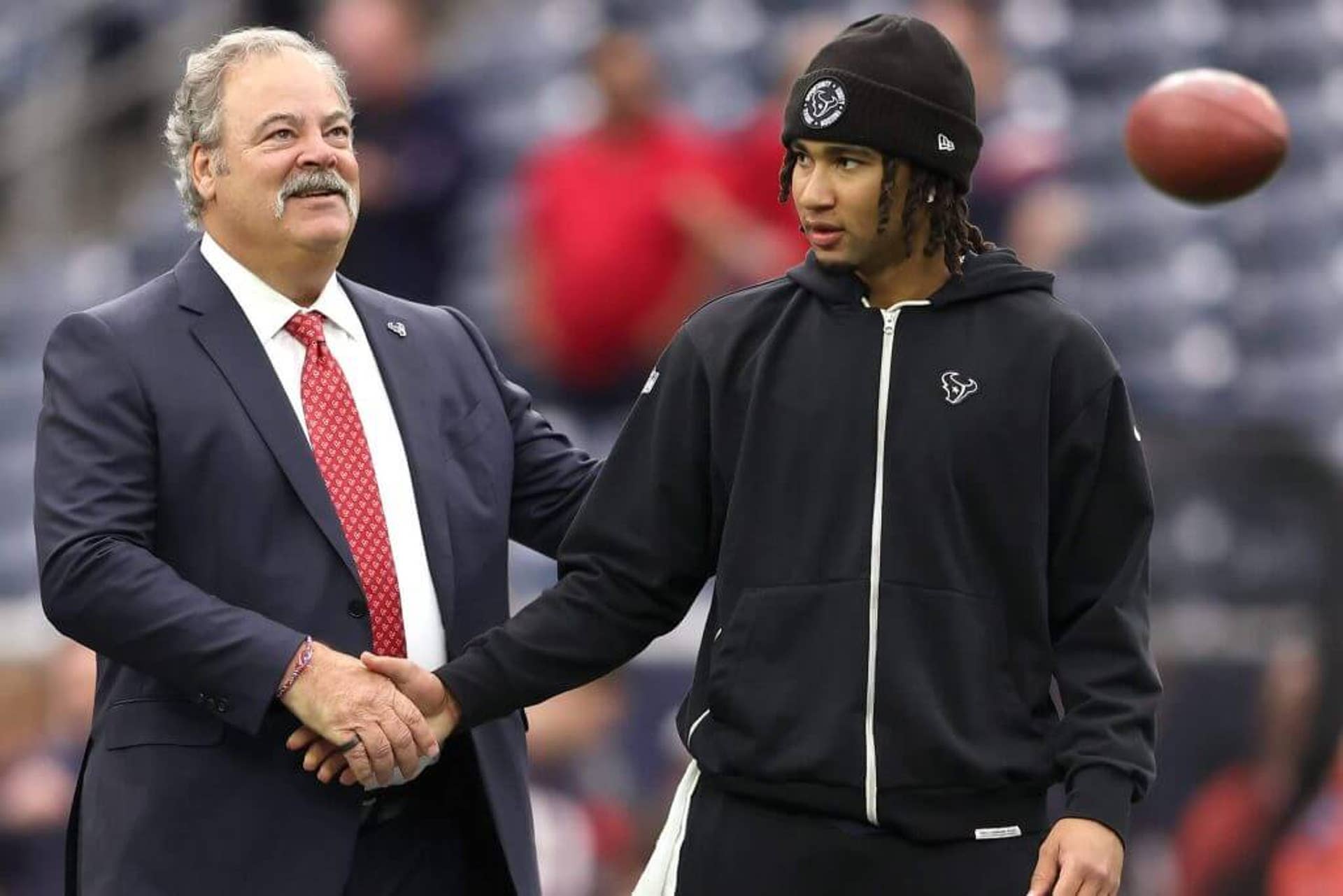 Texans owner Cal McNair, left, and quarterback C.J. Stroud shake hands.