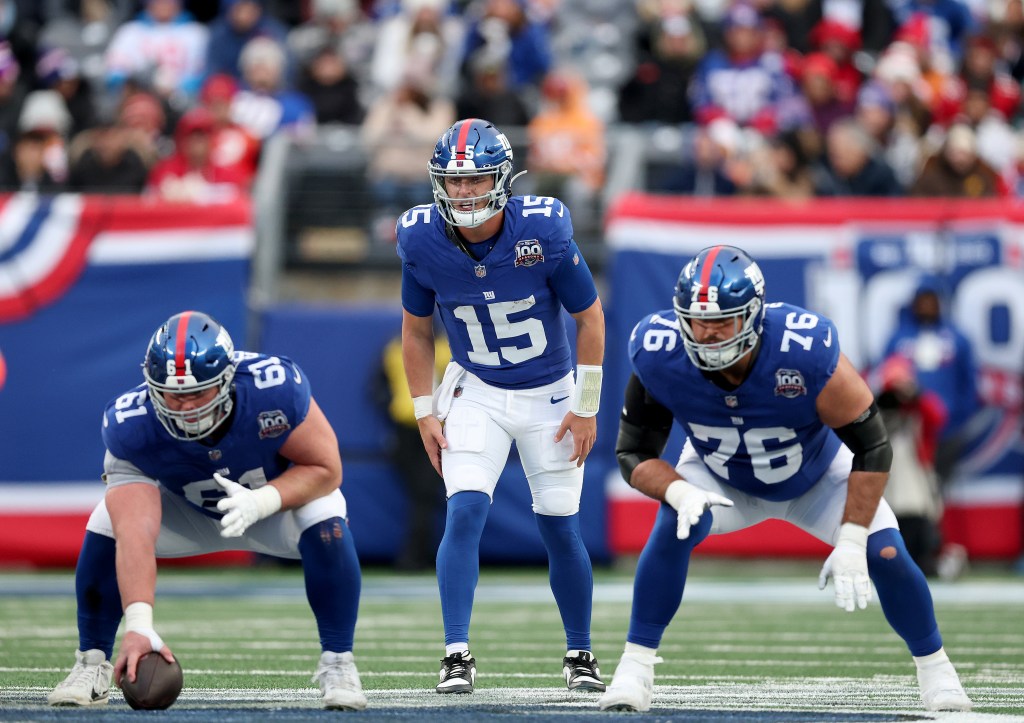Tommy DeVito #15 of the New York Giants calls out the play as John Michael Schmitz Jr. #61 and Jon Runyan #76 look on against the Tampa Bay Buccaneers at MetLife Stadium on November 24, 2024.