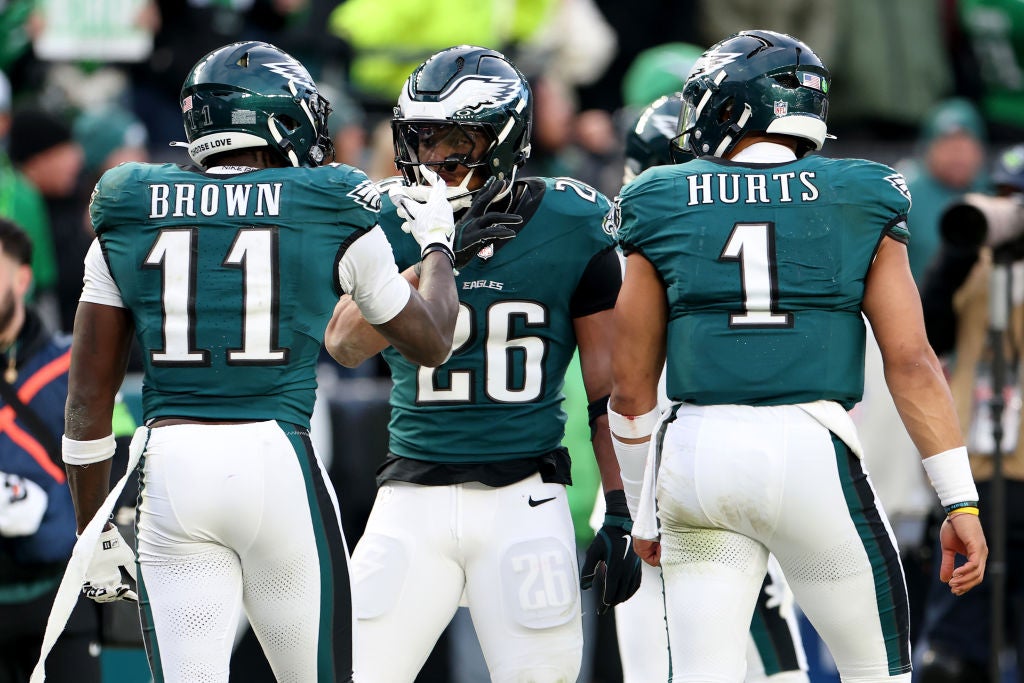 PHILADELPHIA, PENNSYLVANIA - JANUARY 26: A.J. Brown #11 of the Philadelphia Eagles celebrates his touchdown with teammates Saquon Barkley #26 and Jalen Hurts #1 while playing the Washington Commanders during the second quarter in the NFC Championship Game at Lincoln Financial Field on January 26, 2025 in Philadelphia, Pennsylvania.  (Photo by Emilee Chinn/Getty Images)