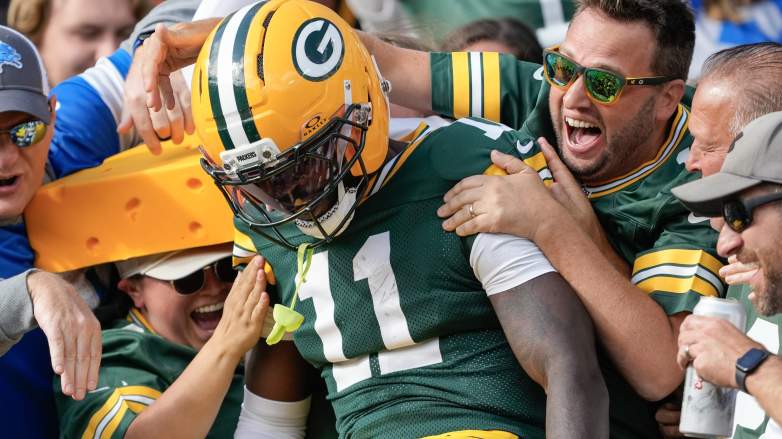 GREEN BAY, WISCONSIN - SEPTEMBER 07: Jayden Reed #11 of the Green Bay Packers jumps into the stands after scoring during the second quarter against the Detroit Lions at Lambeau Field on September 07, 2025 in Green Bay, Wisconsin. (Photo by Patrick McDermott/Getty Images)