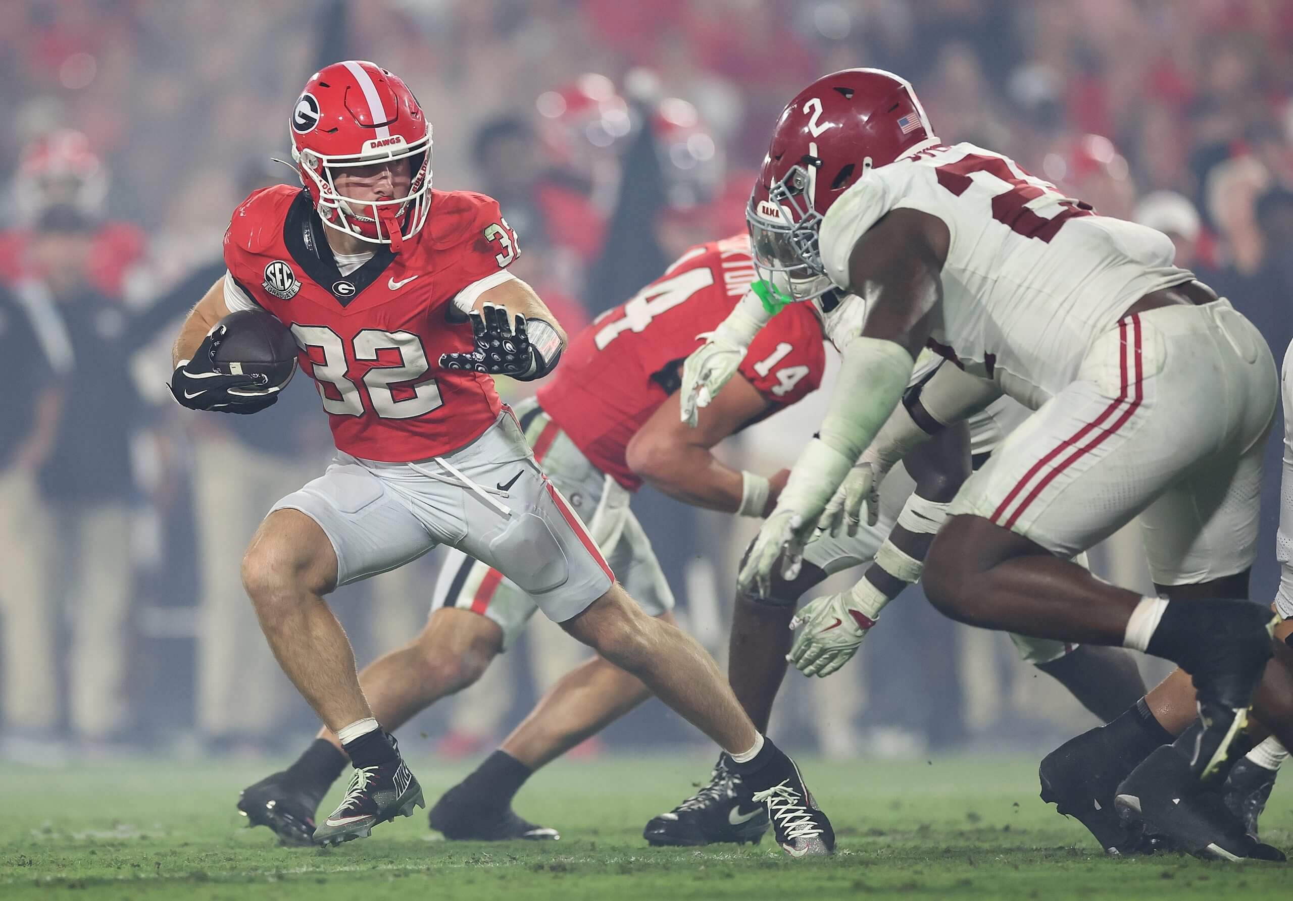 Alabama's Cash Jones runs with the ball with an Alabama defender in pursuit.
