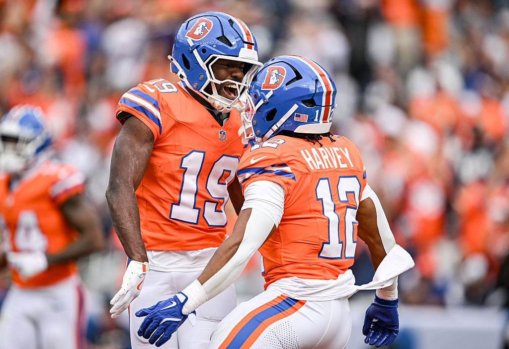 DENVER , CO - OCTOBER 26: RJ Harvey (12) of the Denver Broncos celebrates scoring a rushing touchdown against the Dallas Cowboys with teammate Marvin Mims Jr. (19) during the first quarter at Empower Field at Mile High in Denver on Sunday, October 26, 2025. (Photo by AAron Ontiveroz/The Denver Post)