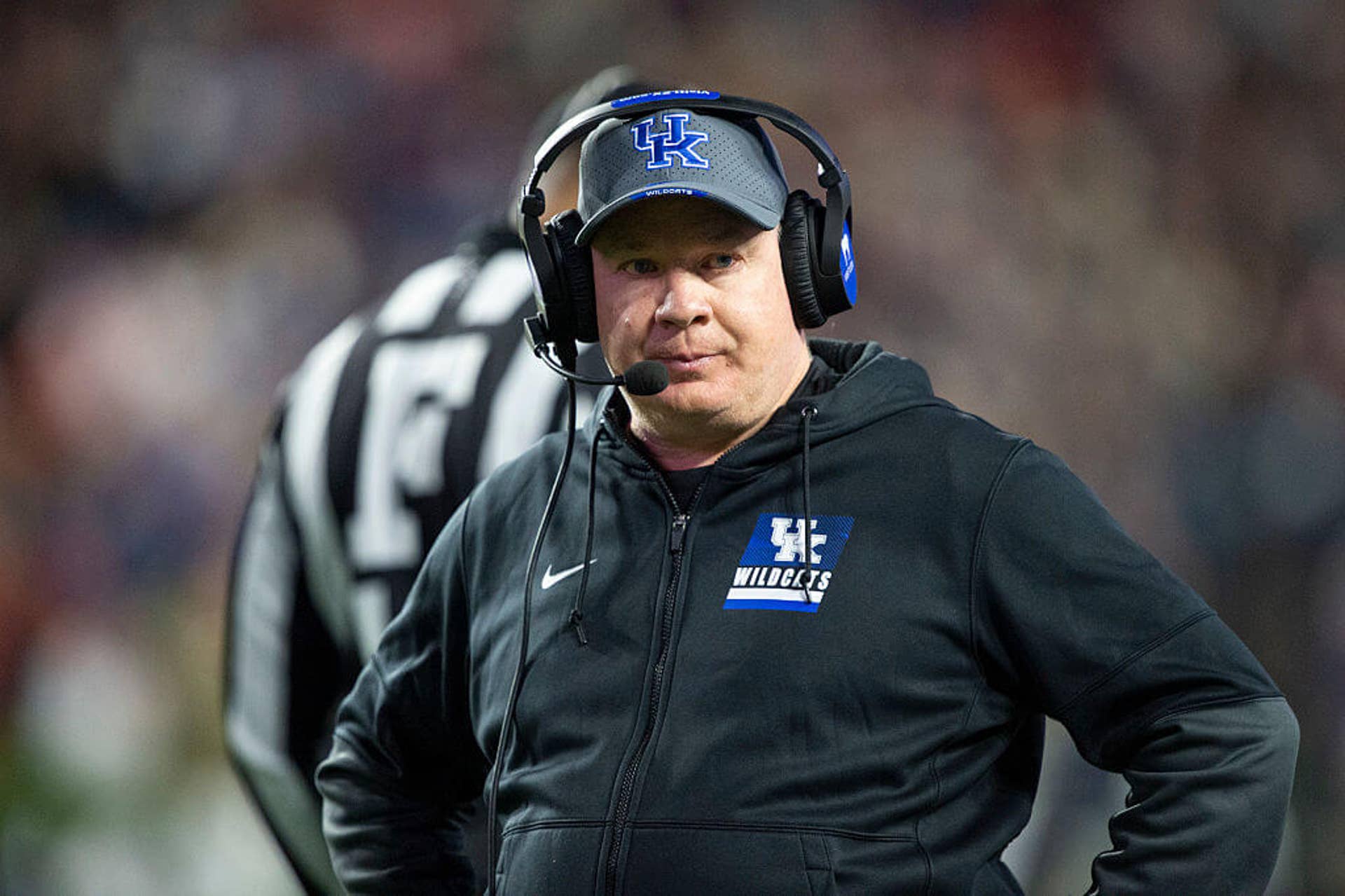 Mark Stoops with a headset on during a game.